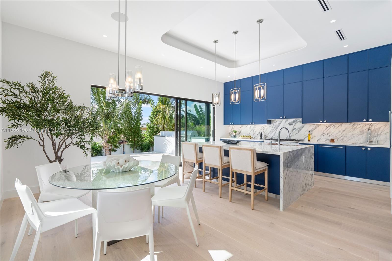 9132 Dickens Avenue Surfside, FL 33154 - Photo 14 of 37 a kitchen with a table and chairs