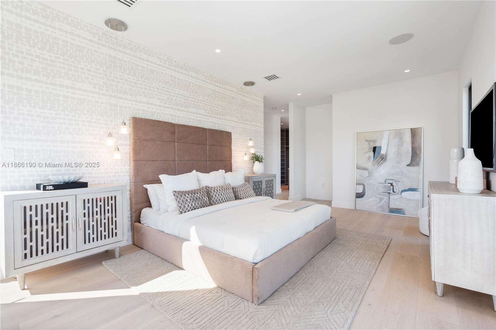 9132 Dickens Avenue Surfside, FL 33154 - Photo 16 of 37 a bedroom with a large bed and a flat tv screen