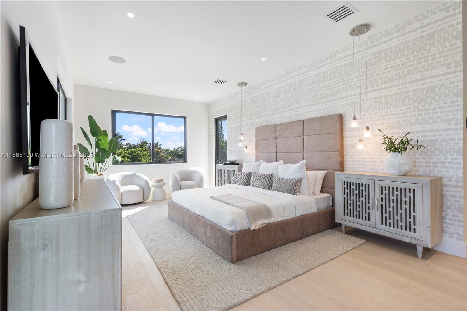 9132 Dickens Avenue Surfside, FL 33154 - Photo 17 of 37 a bedroom with a large bed and a large window