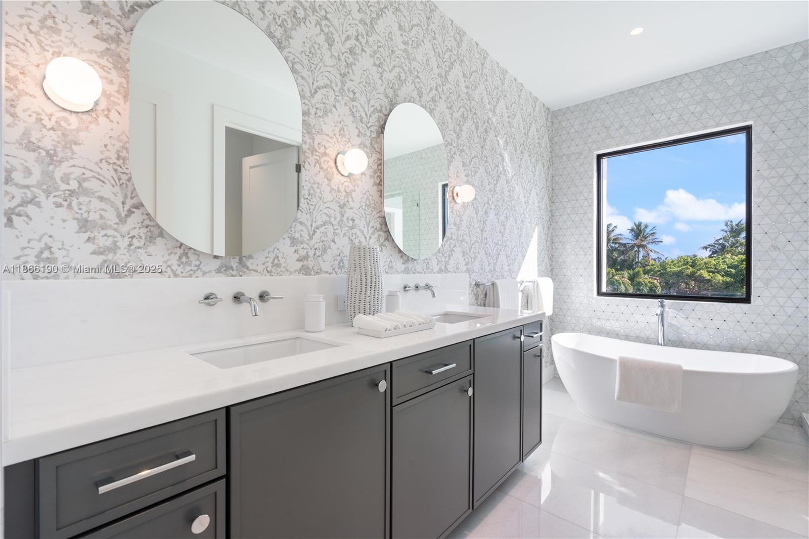 9132 Dickens Avenue Surfside, FL 33154 - Photo 20 of 37 a bathroom with a double vanity sink and a bathtub