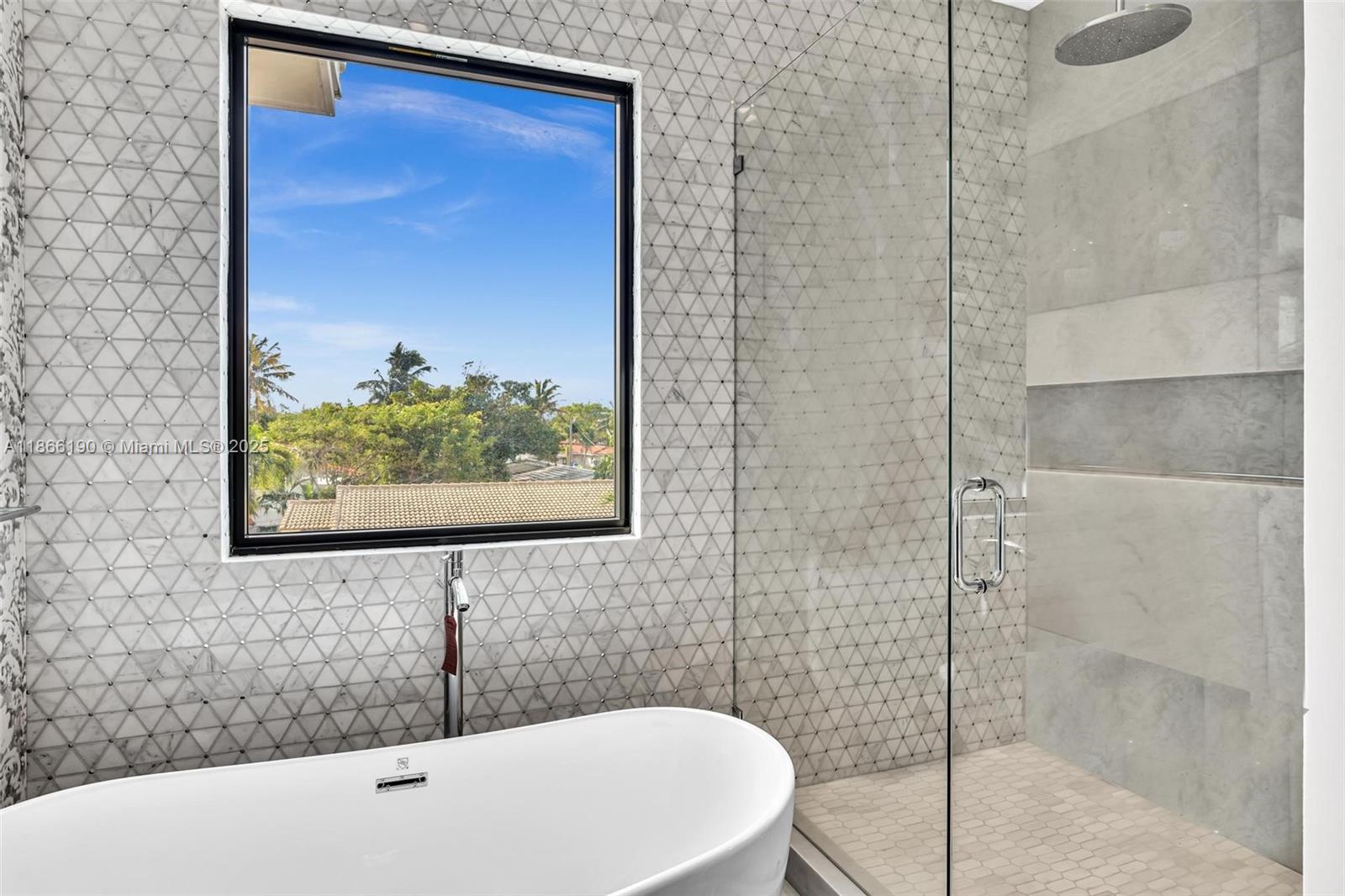 9132 Dickens Avenue Surfside, FL 33154 - Photo 21 of 37 a bathroom with a bathtub and shower