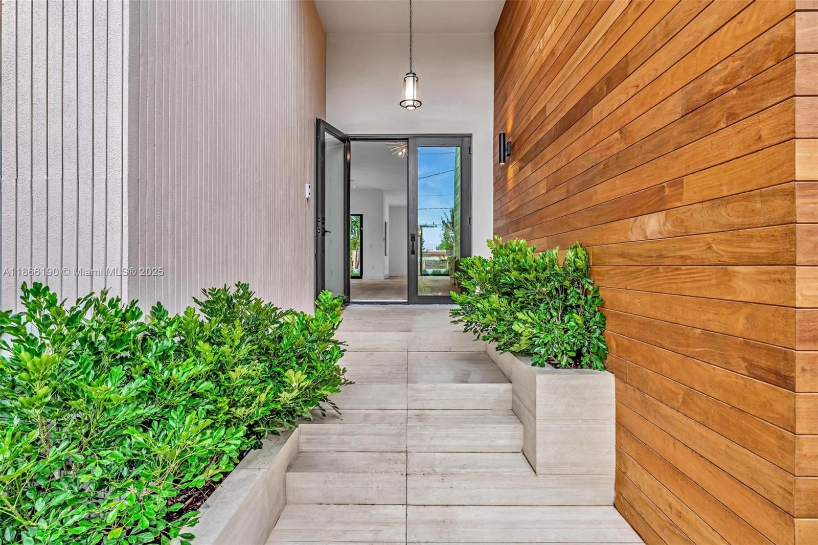 9132 Dickens Avenue Surfside, FL 33154 - Photo 3 of 37 a front view of a house with potted plants