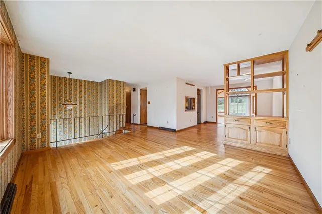 a spacious bedroom with a bed and a cabinets