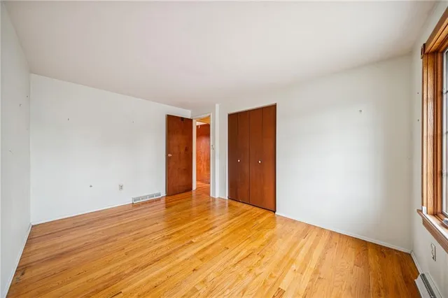 a view of a room with wooden floor and bathroom
