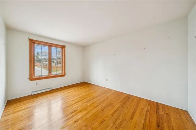 a view of a room with a window and wooden floor