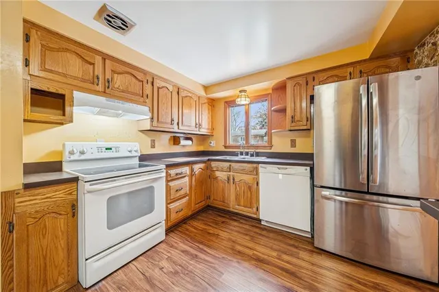 a kitchen with stainless steel appliances a stove a refrigerator and cabinets
