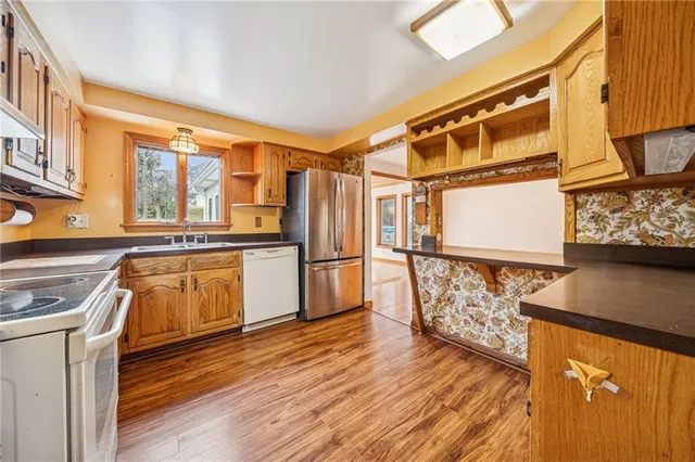 a kitchen with stainless steel appliances a refrigerator and a stove