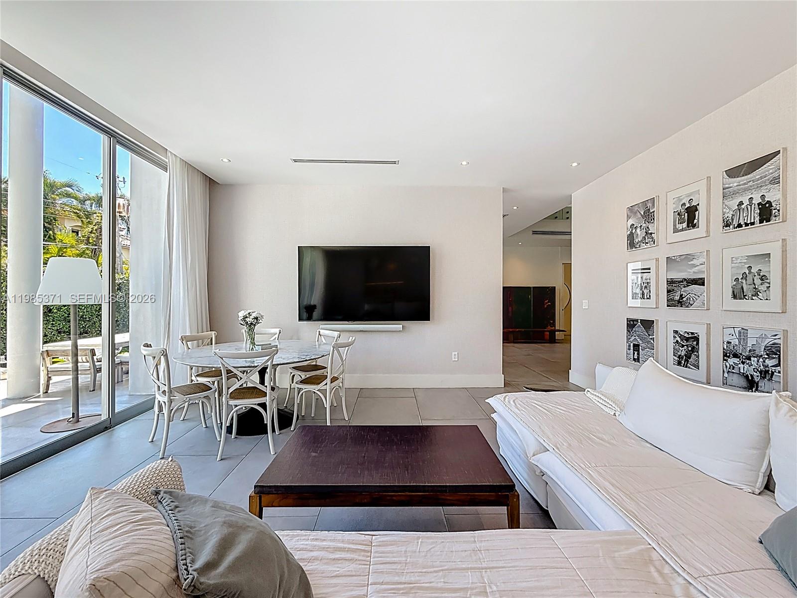 561 Warren Lane Key Biscayne, FL 33149 - Photo 14 of 30 a living room with furniture a flat screen tv and a large window