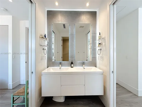 a bathroom with a double vanity sink mirror and double