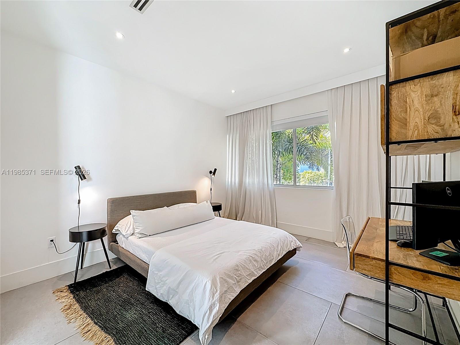 561 Warren Lane Key Biscayne, FL 33149 - Photo 30 of 30 a bedroom with a bed and wooden floor