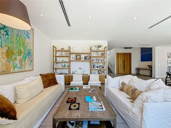 a living room with furniture and a floor to ceiling window
