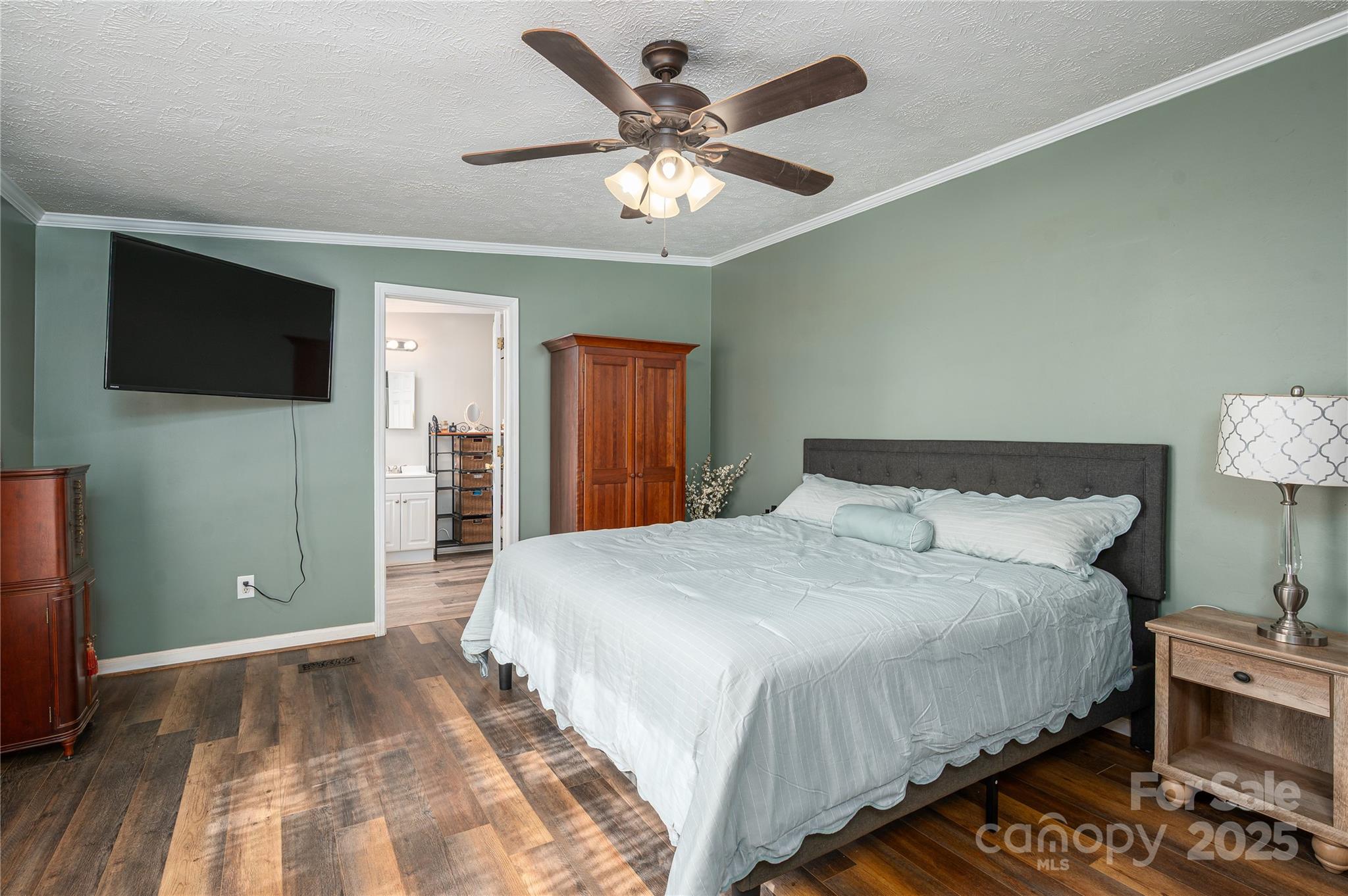 6636 Old Plank Road Stanley, NC 28164 - Photo 16 of 22 a bedroom with bed and a flat tv screen on dresser