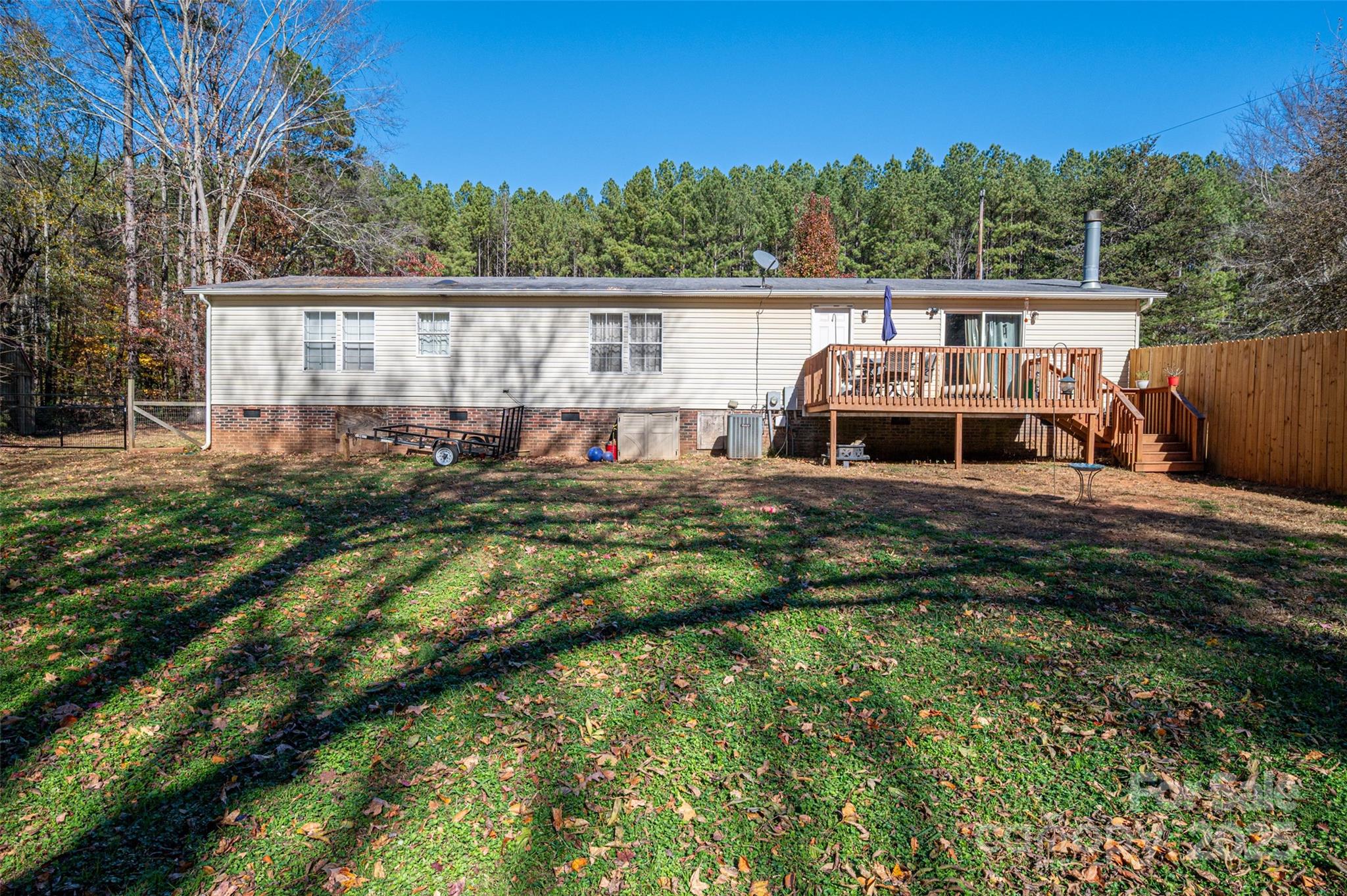 6636 Old Plank Road Stanley, NC 28164 - Photo 18 of 22 a view of a house with backyard sitting area and garden