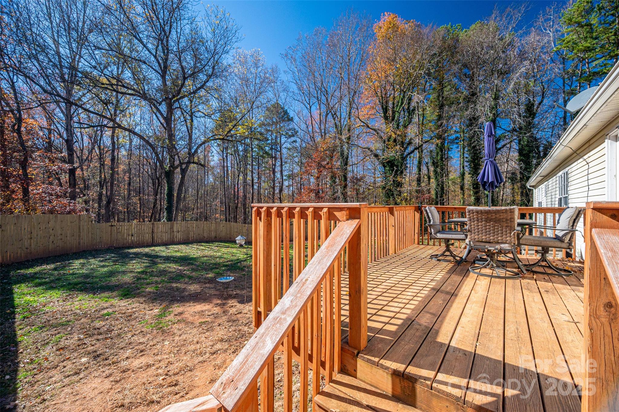 6636 Old Plank Road Stanley, NC 28164 - Photo 20 of 22 a balcony with wooden floor and trees in the background