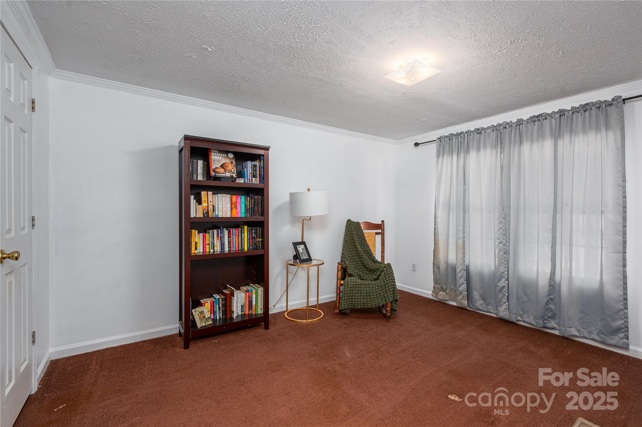 6636 Old Plank Road Stanley, NC 28164 - Photo 7 of 22 a view of an empty room with furniture and a book shelf