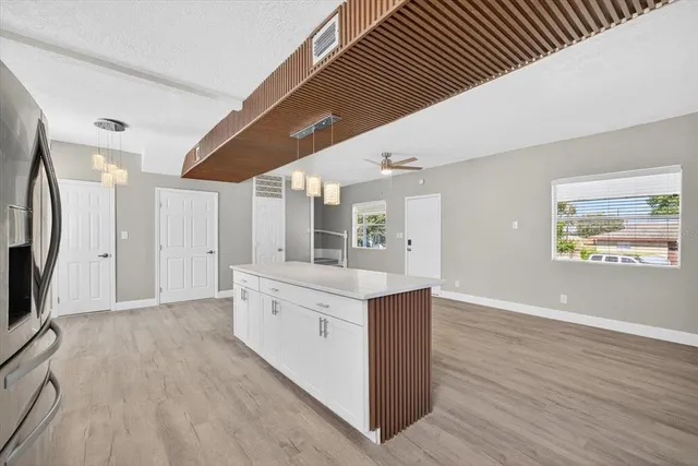a view of kitchen with stainless steel appliances cabinets and wooden floor