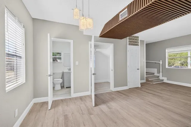 wooden floor in an empty room with a window