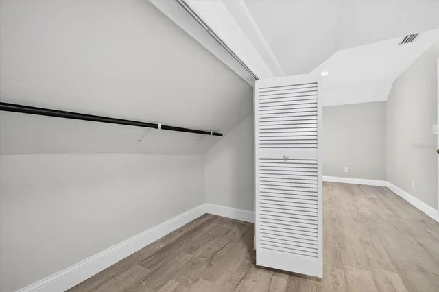 a view of a room with wooden floor and white walls