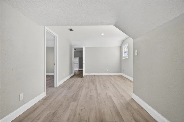 a view of a room with wooden floor