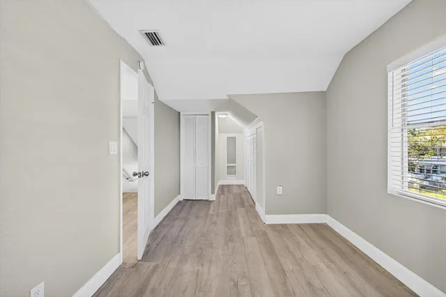 a view of room with window and wooden floor