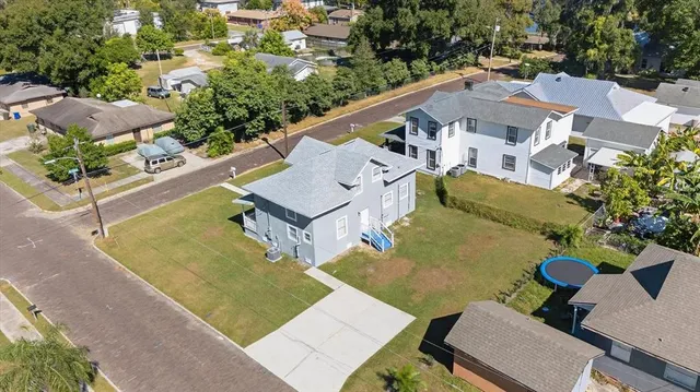 an aerial view of a house with a swimming pool