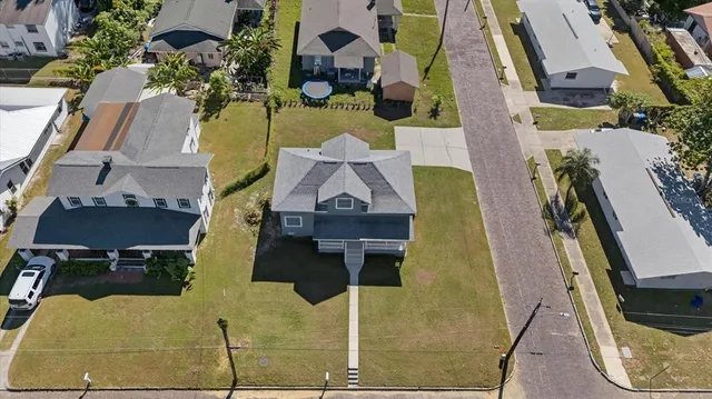 an aerial view of residential houses with outdoor space
