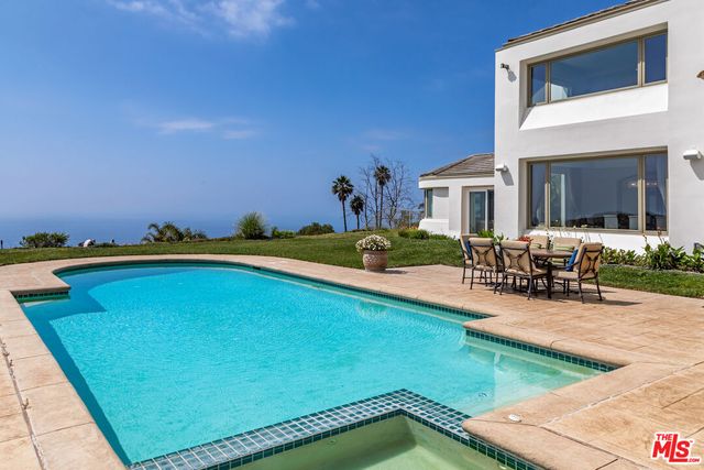a view of swimming pool with outdoor seating