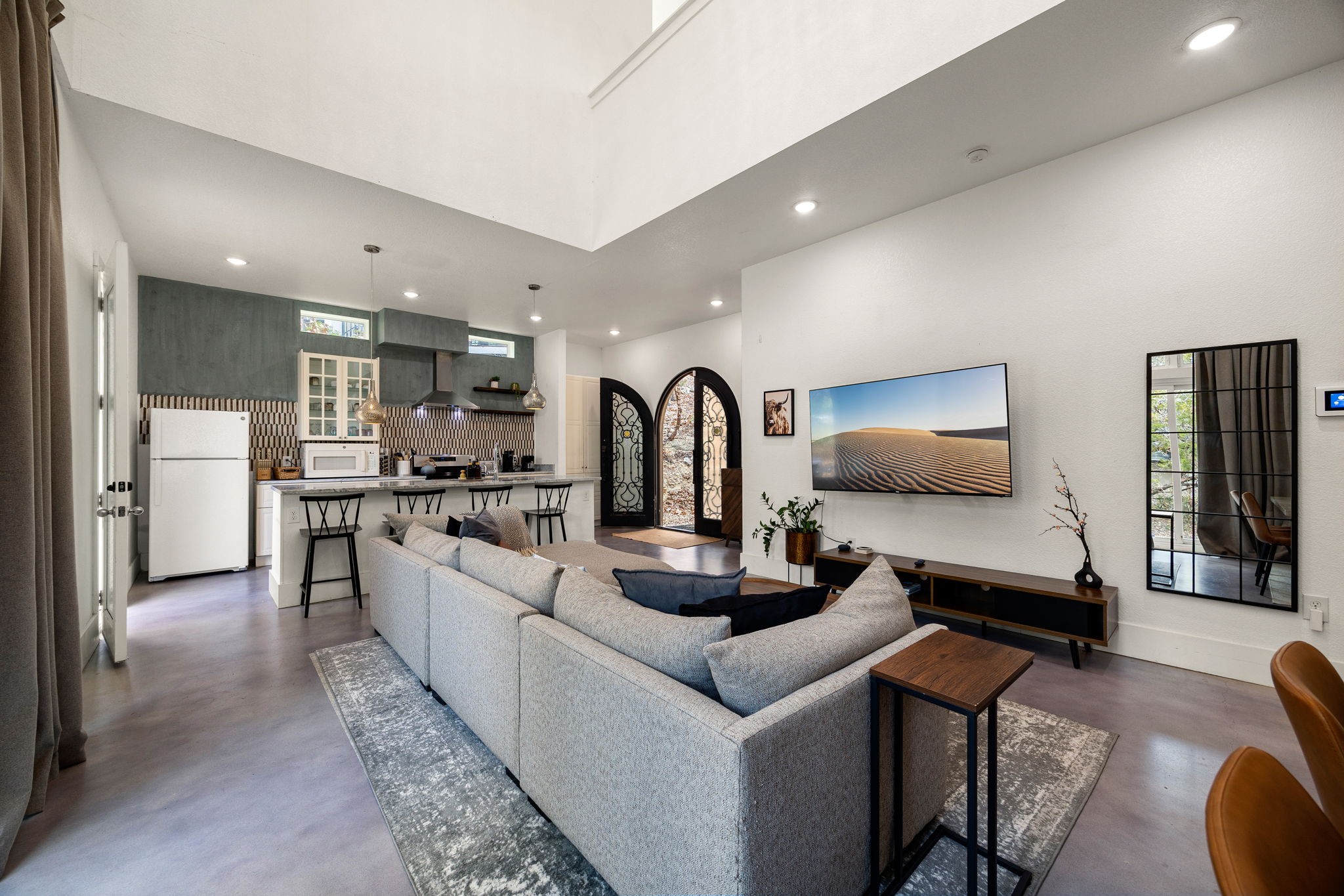 12808 Hughes Street Austin, TX 78732 - Photo 11 of 40 a living room with furniture a flat screen tv and kitchen view