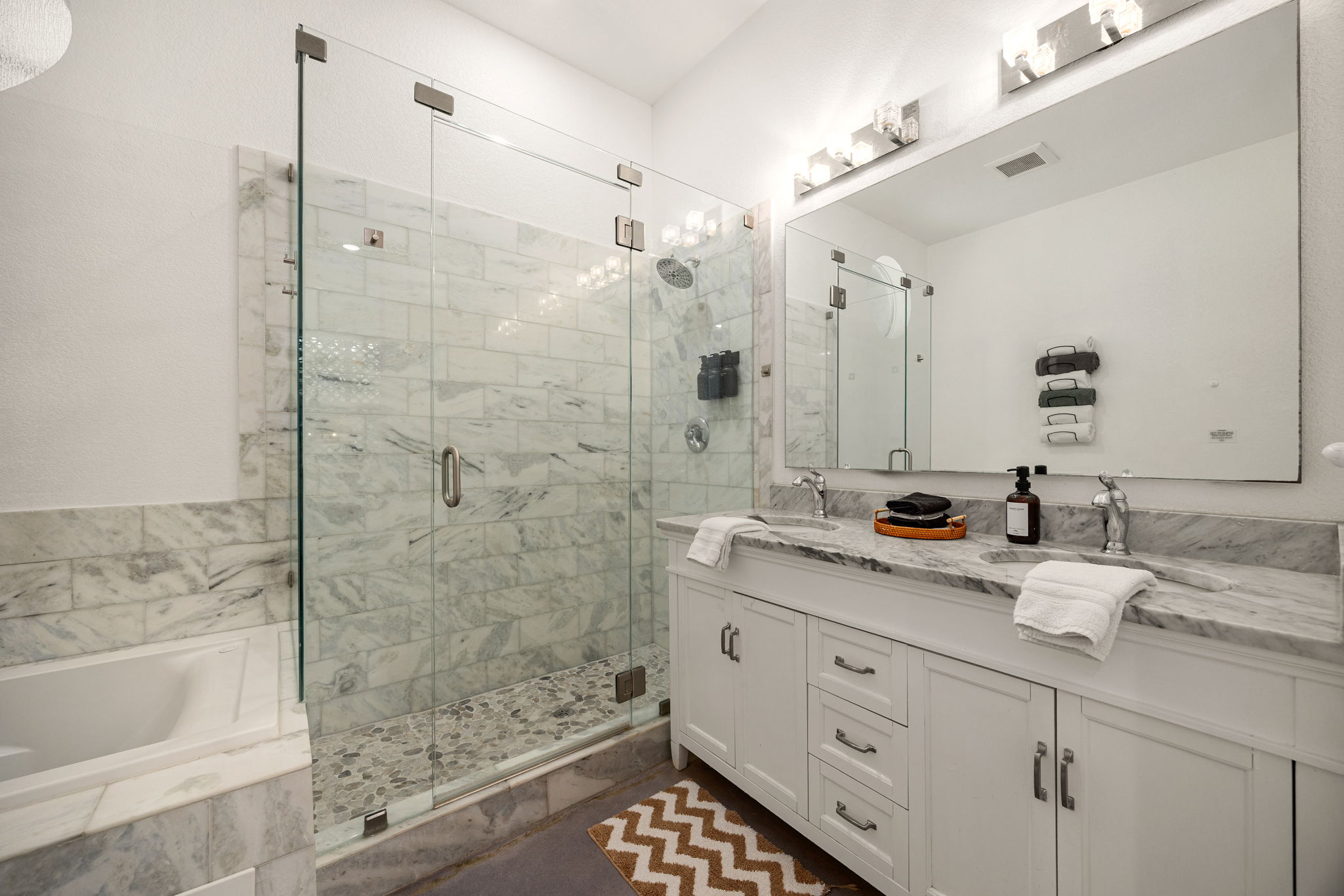 12808 Hughes Street Austin, TX 78732 - Photo 15 of 40 a bathroom with a granite countertop sink mirror and shower