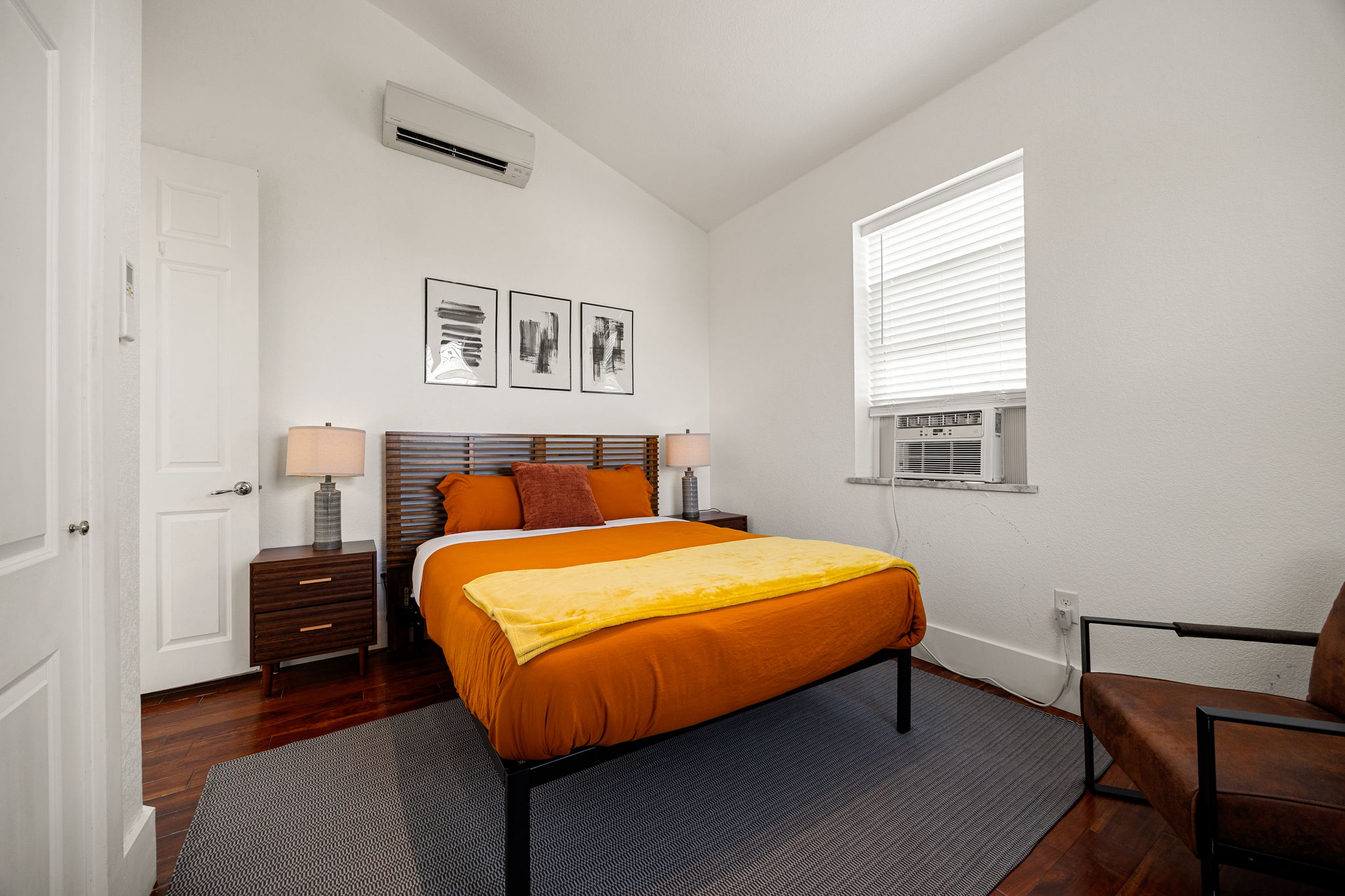 12808 Hughes Street Austin, TX 78732 - Photo 20 of 40 a bedroom with a bed and wooden floor