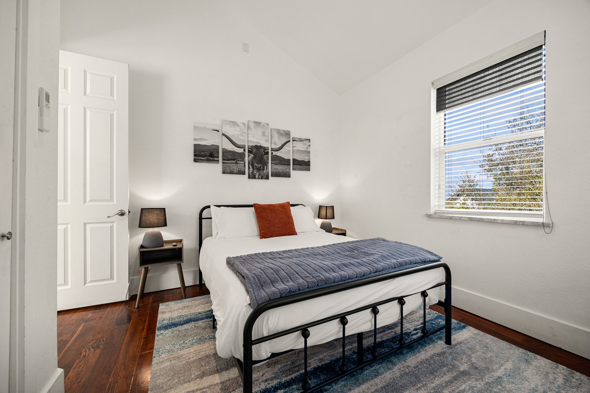 12808 Hughes Street Austin, TX 78732 - Photo 24 of 40 a bedroom with a bed and wooden floor