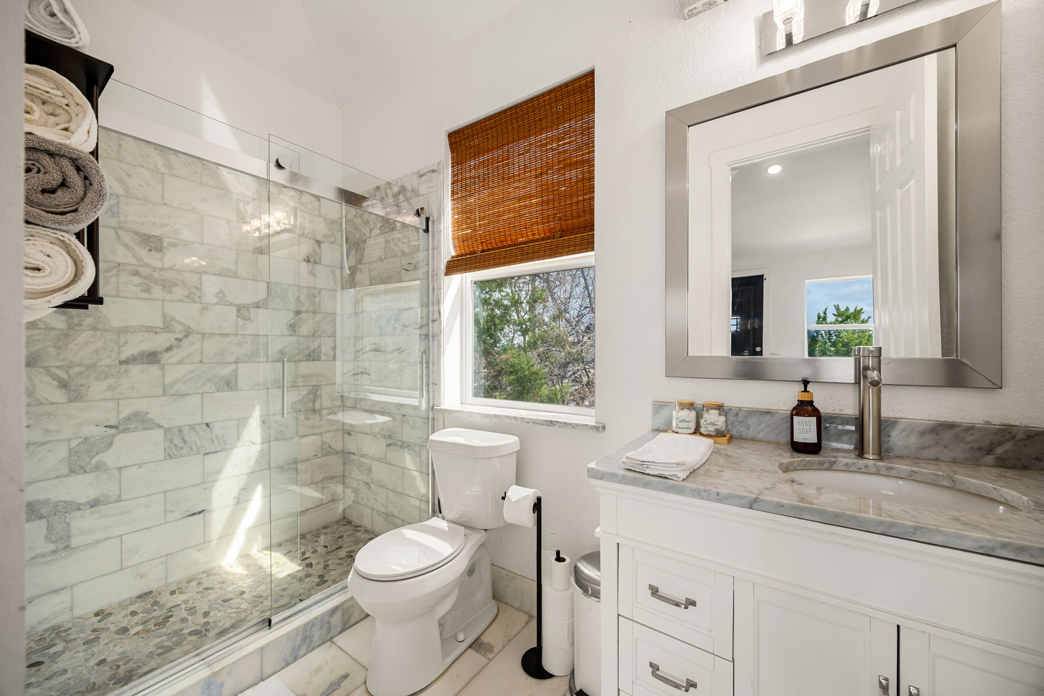 12808 Hughes Street Austin, TX 78732 - Photo 34 of 40 a bathroom with a granite countertop toilet sink and mirror