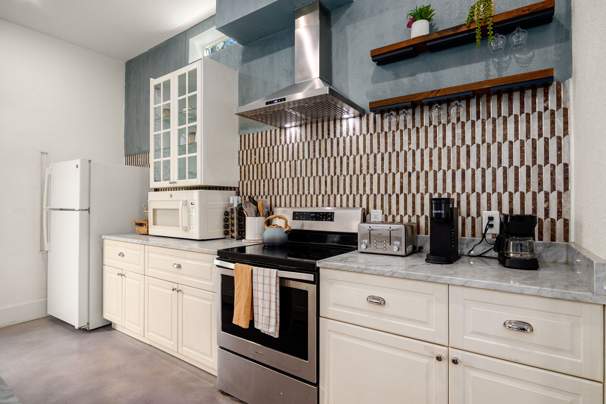 12808 Hughes Street Austin, TX 78732 - Photo 6 of 40 a kitchen with granite countertop white cabinets and white appliances