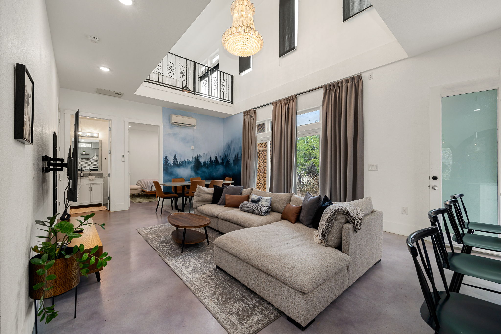 12808 Hughes Street Austin, TX 78732 - Photo 8 of 40 a living room with furniture and a chandelier