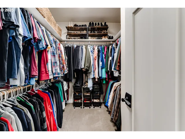 a view of walk in closet with clothes
