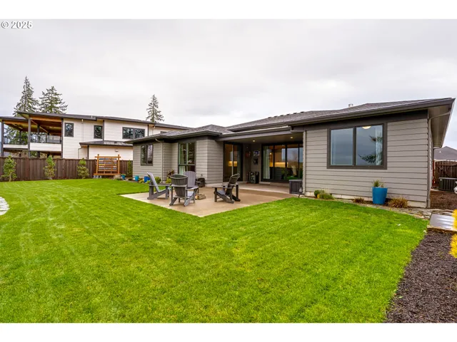 a backyard of a house with table and chairs
