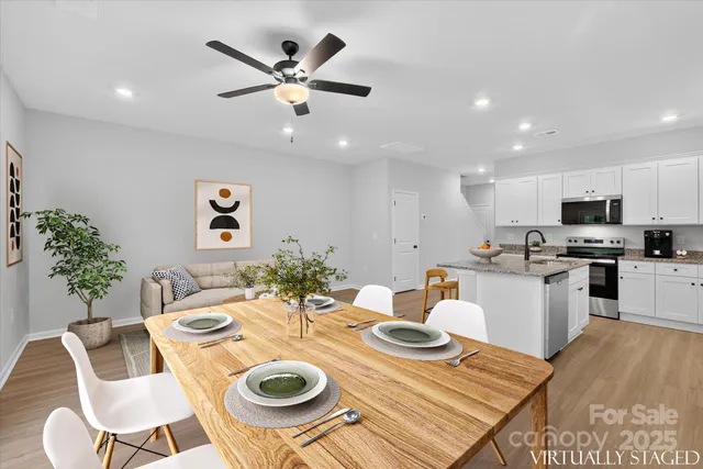 a kitchen with a dining table and chairs