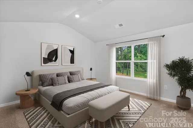 a bedroom with a bed and a potted plant