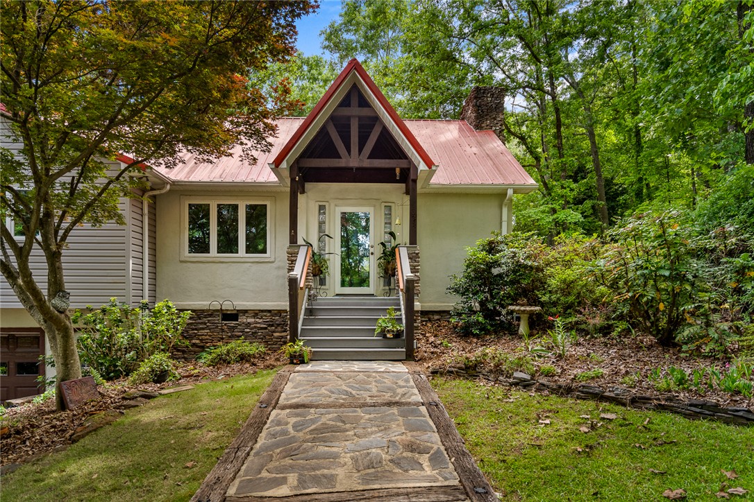 324 Hobson Road Anderson, SC 29621 - Photo 3 of 46 This captivating residence features a welcoming stone pathway leading to a charming covered porch.