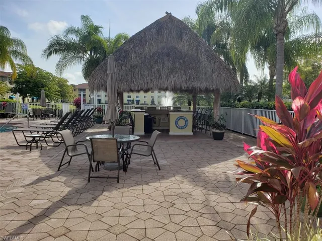 a view of a patio with a table and chairs under an umbrella