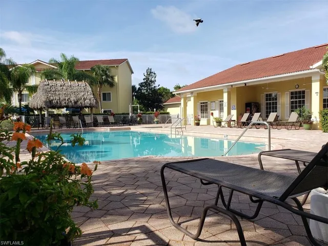 a view of a house with backyard porch and sitting area