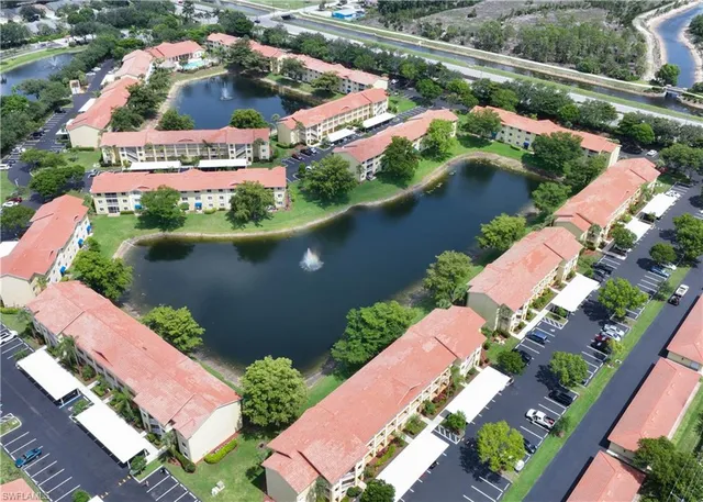 an aerial view of a house with a lake view