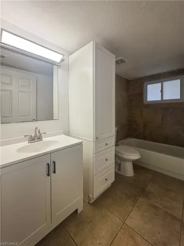 a bathroom with a double vanity sink toilet and mirror