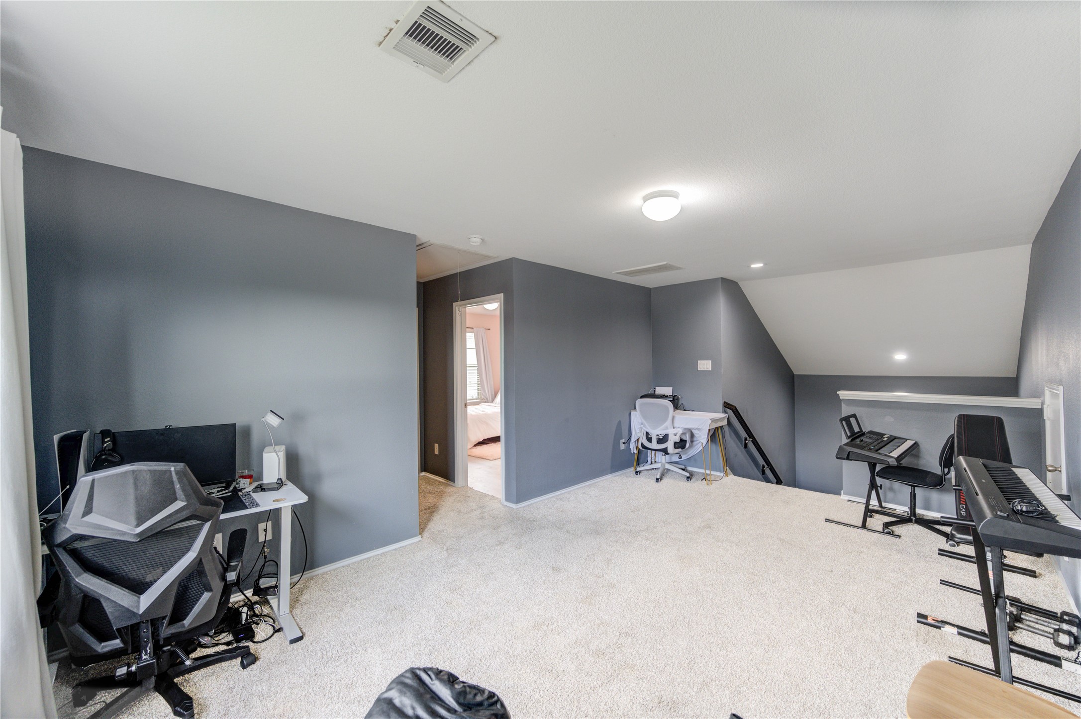 2306 Rainier Mist Road Spring, TX 77373 - Photo 25 of 28 Game room - A staircase leads to the lower level.