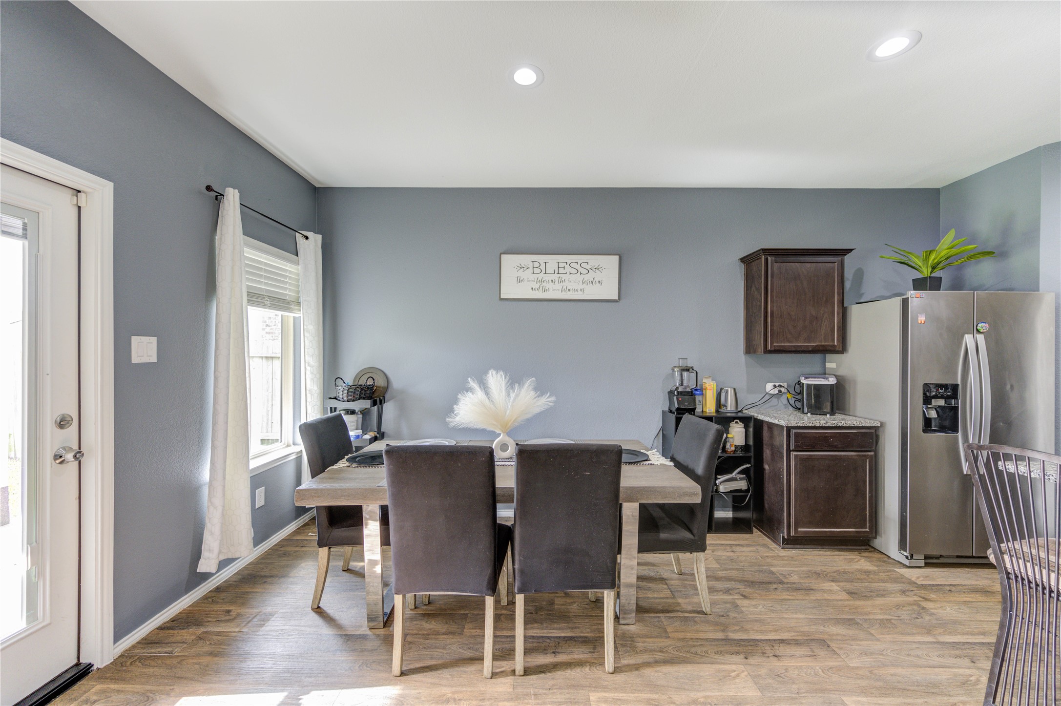 2306 Rainier Mist Road Spring, TX 77373 - Photo 5 of 28 Dining room - Natural light streams through a window and a glass door, creating an airy atmosphere.