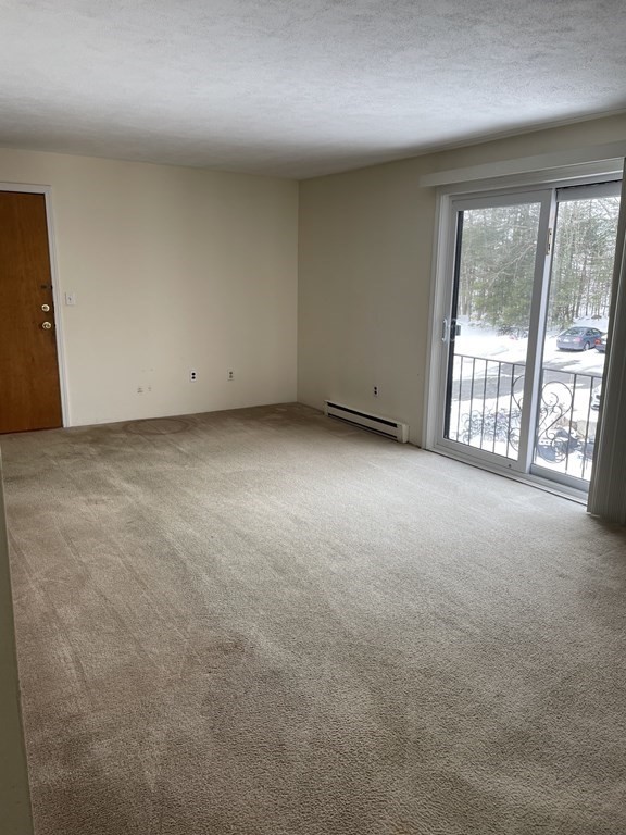 388 Great Road, Unit A11 Acton, MA 01720 - Photo 4 of 11 an empty room with windows