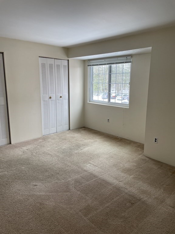 388 Great Road, Unit A11 Acton, MA 01720 - Photo 5 of 11 a view of an empty room with a window