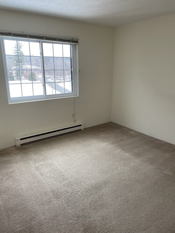 388 Great Road, Unit A11 Acton, MA 01720 - Photo 6 of 11 an empty room with a window
