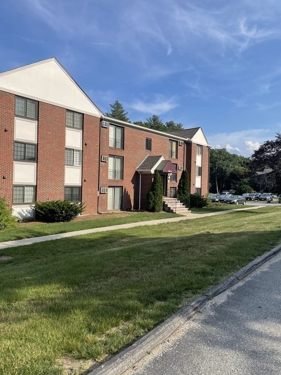 388 Great Road, Unit A11 Acton, MA 01720 - Photo 8 of 11 a front view of house with yard and outdoor seating