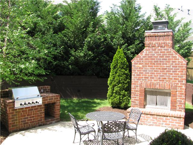 Grill and wood burning fireplace just off covered rear patio.